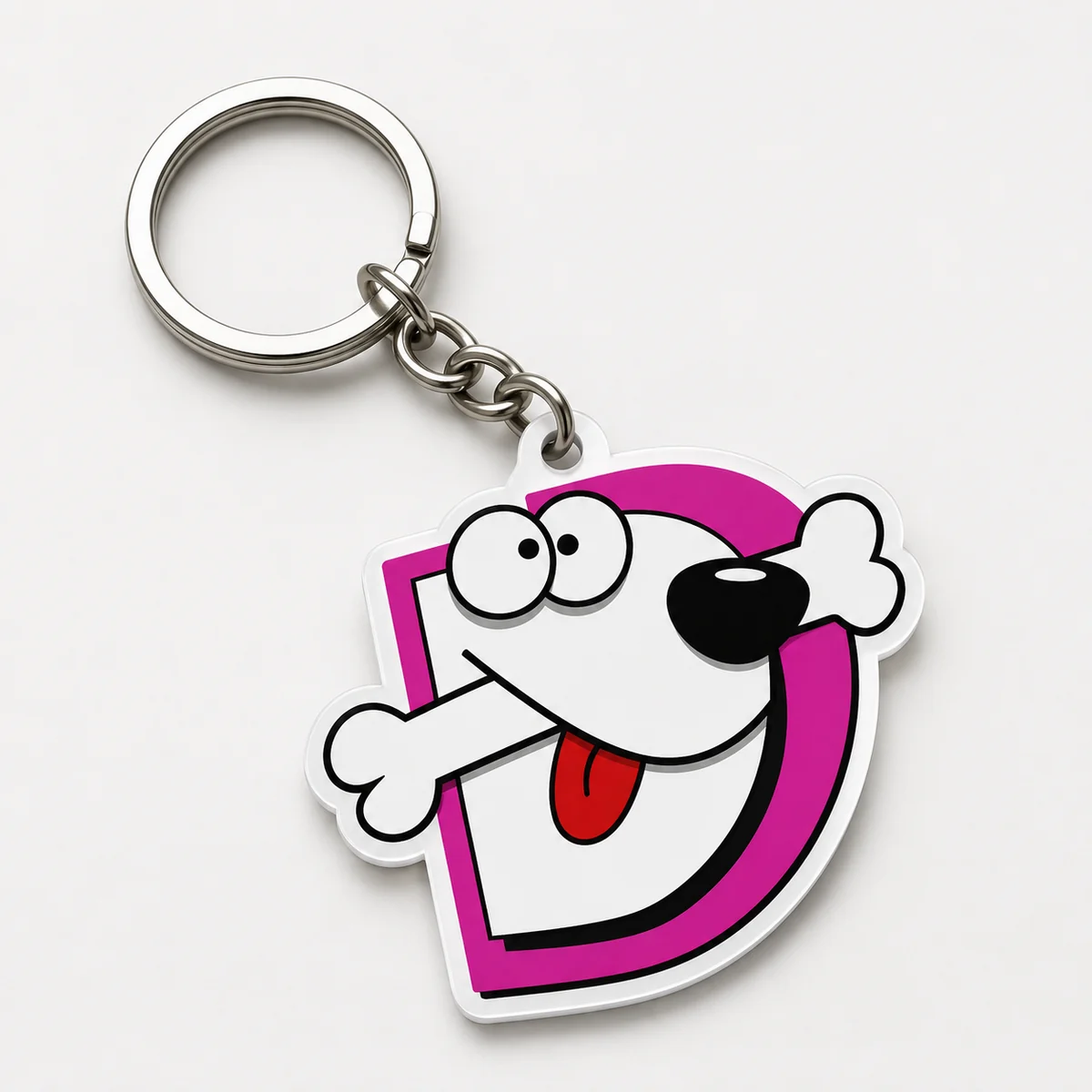 Llavero de goma con la D de Defaniva y su perro: la mascota funcionando sola como pieza de merchandising